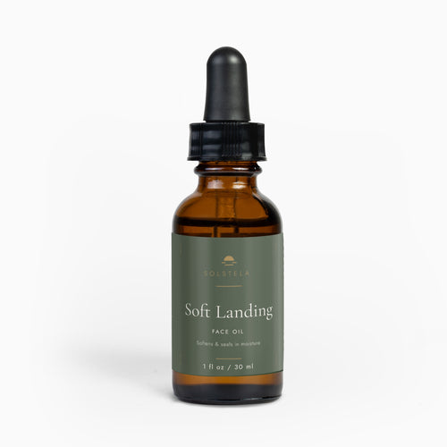Solstela Soft Landing face oil, amber glass dropper bottle with a sage-green label, on a plain pale background